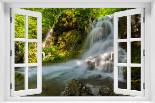 Fototapeta Naklejka Na Ścianę Okno 3D - Pretty waterfalls deep in the woods, on a bright sunny day in spring