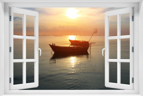 Fototapeta Naklejka Na Ścianę Okno 3D - Silhouette natural background of small fishing boats moored beached on the beach during time the sunset and the beautiful natural of the colorful sky at BangPhra beach , Chonburi province in Thailand