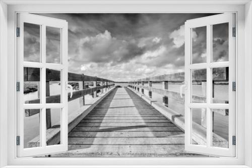 Fototapeta Naklejka Na Ścianę Okno 3D - Wooden footbridge in the marshes. Black & White