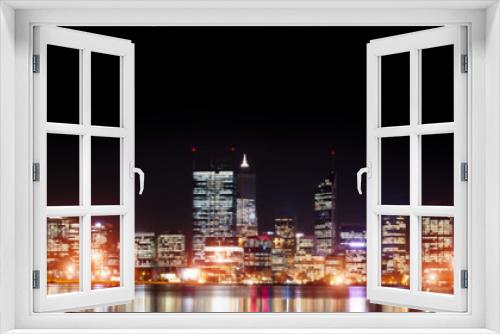 Fototapeta Naklejka Na Ścianę Okno 3D - Businesswoman viewing night glowing city