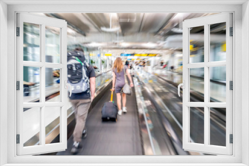 tourists on escalator in the airport