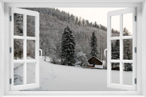 Fototapeta Naklejka Na Ścianę Okno 3D - A farmhouse in winter covered in snow