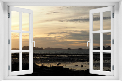 Fototapeta Naklejka Na Ścianę Okno 3D - Rock silhouettes and vivid sunset while low tide