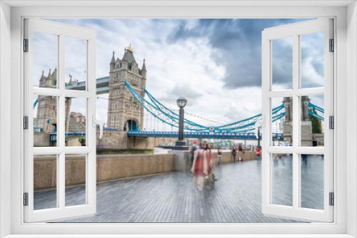Fototapeta Naklejka Na Ścianę Okno 3D - Tourists along Tower Bridge in London. Blurred long exposure vie