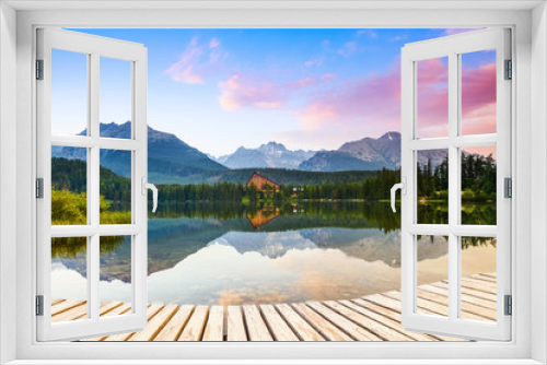 Fototapeta Naklejka Na Ścianę Okno 3D - An old pier reveals views of the charmed lake, green mountains.