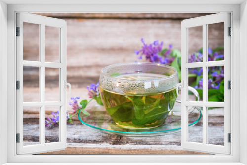 Fototapeta Naklejka Na Ścianę Okno 3D - A glass cup of herbal catmint tea