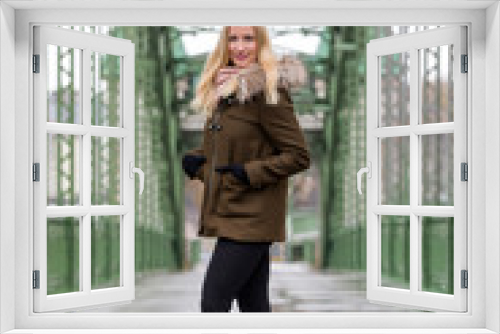 Attractive blonde woman wearing winter jacket on street