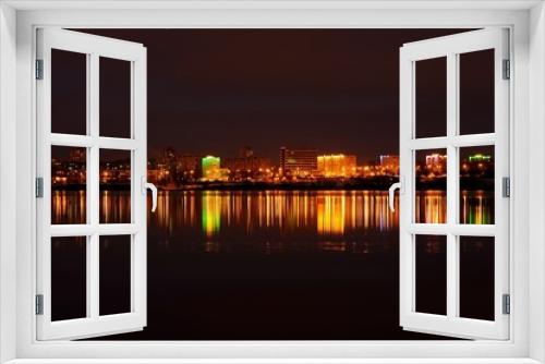 Fototapeta Naklejka Na Ścianę Okno 3D - evening city landscape with reflection in the ice lake