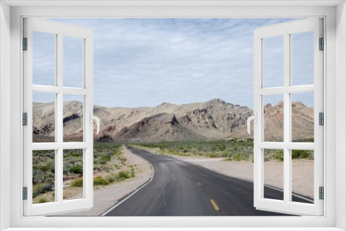 Fototapeta Naklejka Na Ścianę Okno 3D - Road going towards arid mountains