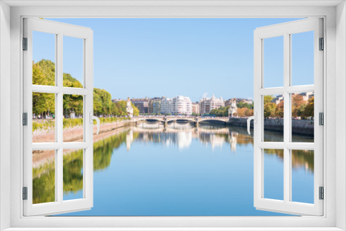 Fototapeta Naklejka Na Ścianę Okno 3D - The Urumea river is passing through the Basque city of Donostia San Sebastian. View ahead to the Maria Cristina bridge and the district Gros. The Basque river is flowing into the Bay of Biscay