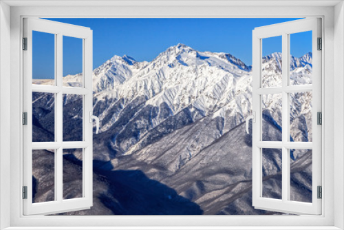 Fototapeta Naklejka Na Ścianę Okno 3D - Beautiful mountain winter scenery of the Main Caucasian ridge with snowy peaks on blue sky background