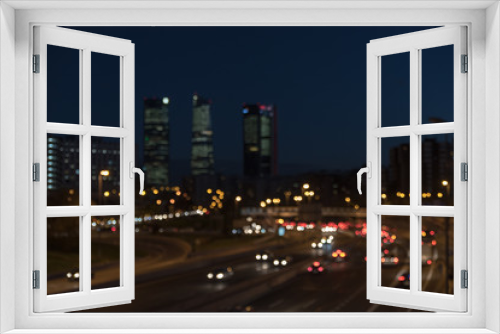 Fototapeta Naklejka Na Ścianę Okno 3D - Bokeh de las luces de Madrid de noche con las cuatro torres de fondo.