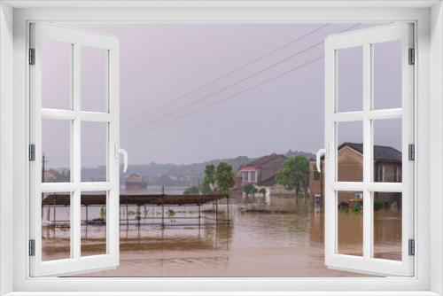 Fototapeta Naklejka Na Ścianę Okno 3D - flooded road junction with House in floodwater on rainy day