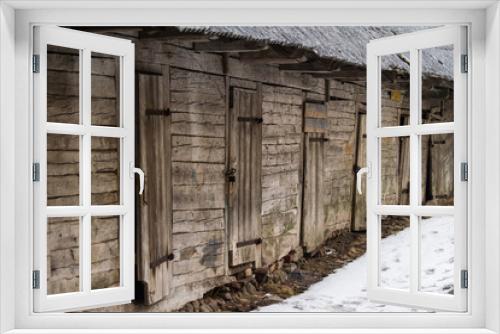 Fototapeta Naklejka Na Ścianę Okno 3D - An old wooden building in a winter landscape