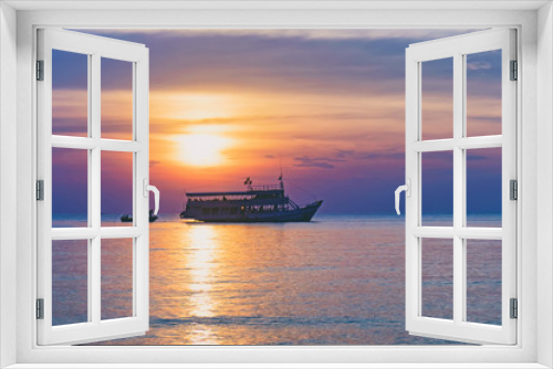 Fototapeta Naklejka Na Ścianę Okno 3D - Tropical colorful dramatic sunset with cloudy sky and silhouette of the ship on the horizon. Evening calm on the Gulf of Thailand. Bright afterglow.