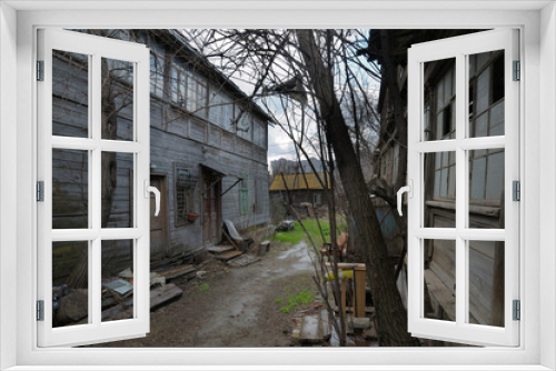 Fototapeta Naklejka Na Ścianę Okno 3D - abandoned wooden housing, the old yard. Emergency housing.