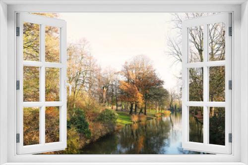 Fototapeta Naklejka Na Ścianę Okno 3D - Picturesque autumn landscape with bright blue sky, yellow leaves and steady river in Brugge, Belgium
