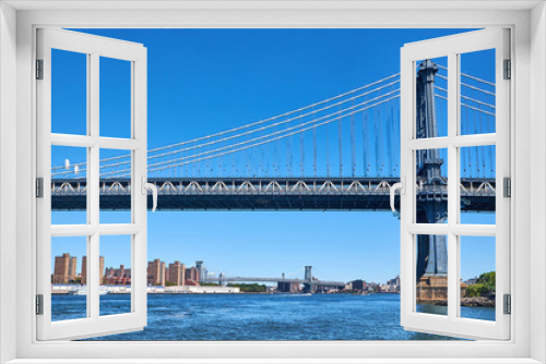 Fototapeta Naklejka Na Ścianę Okno 3D - Manhattan Bridge crossing East River with Williamsburg Bridge in the background in New York City