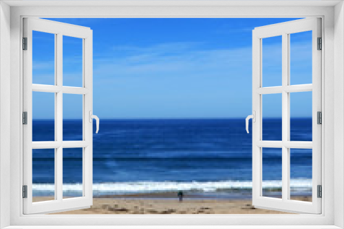 Fototapeta Naklejka Na Ścianę Okno 3D - Man at Beach looking at Endless Horizon with clear blue sky - near Monterey at the Pacific Coast (vertical)