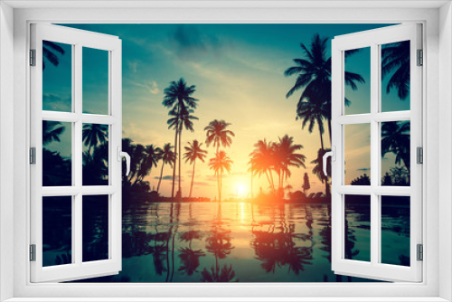 Fototapeta Naklejka Na Ścianę Okno 3D - Sunset on a tropical resort beach with silhouettes of palm trees.