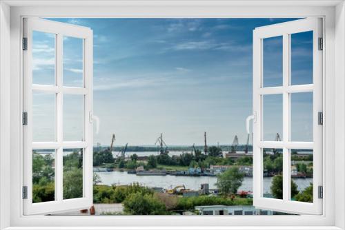 Fototapeta Naklejka Na Ścianę Okno 3D - River Industrial Zone with cranes for loading ships. Blue sky with copy space