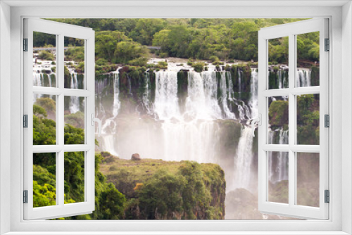 Fototapeta Naklejka Na Ścianę Okno 3D - View of the Iguazu (Iguacu) falls, the largest series of waterfalls on the planet, located between Brazil, Argentina, and Paraguay with up to 275 separate waterfalls 