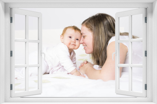 Portrait of a crawling baby on the bed in her room