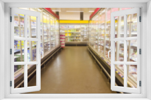 blurred image of  supermarket aisle with shelves full of products