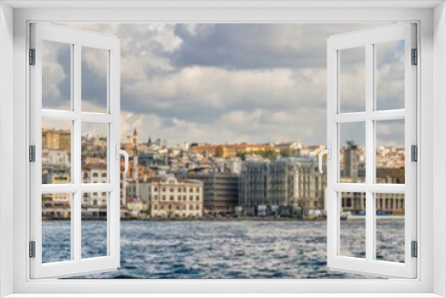 Panorama of Cityscape of Golden horn with ancient and modern buildings in Istanbul Turkey from the Bosphorus strait on a sunny day with background cloudy sky