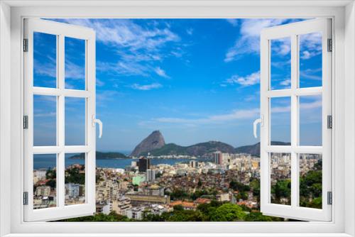 Fototapeta Naklejka Na Ścianę Okno 3D - Urban view of Rio de Janeiro city with Sugarloaf Mountain, residential houses and a nearby slum favela adjacent to the hillside of Santa Teresa district