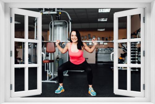 Beautiful fitness woman lifting barbell.