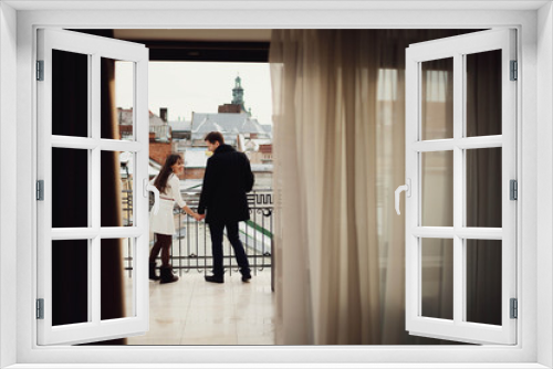 beautiful and young couple standing together on terrace