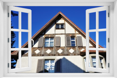 Fototapeta Naklejka Na Ścianę Okno 3D - Renovated House-Front with Dormer Windows (Gauben) at tiled Roof (Ziegeldach)
