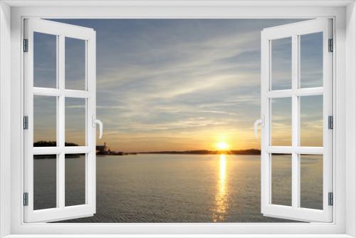 Fototapeta Naklejka Na Ścianę Okno 3D - A view of the calm golden sunset on the river with the sun reflected in it, Volga, Russia