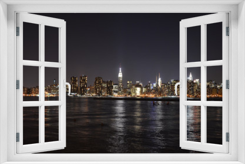 Fototapeta Naklejka Na Ścianę Okno 3D - New York Skyline reflected in water, view at night from Brooklyn