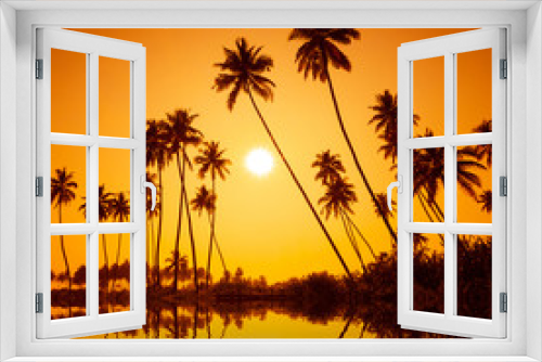 Fototapeta Naklejka Na Ścianę Okno 3D - Palm trees silhouettes on tropical beach at summer warm vivid sunset with reflection in calm water