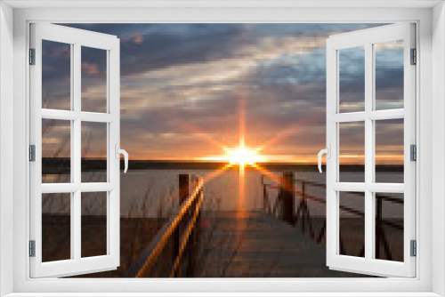 Fototapeta Naklejka Na Ścianę Okno 3D - sunrise sunburst over a fishing dock