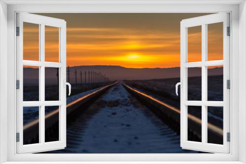 Fototapeta Naklejka Na Ścianę Okno 3D - Railway receding into the distance at sunrise