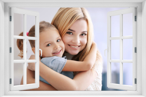 Beautiful young woman and her daughter at home. Mother's day concept