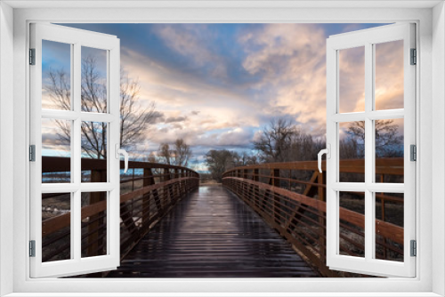 Fototapeta Naklejka Na Ścianę Okno 3D - Rain-Slick Footbridge At Sunset