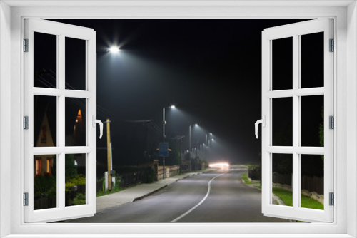 Fototapeta Naklejka Na Ścianę Okno 3D - empty village road at night