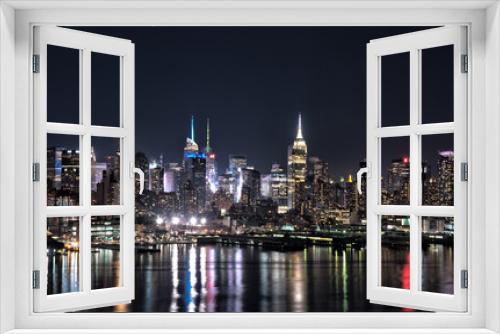 Fototapeta Naklejka Na Ścianę Okno 3D - New York city skyline at night with building lights reflected in Hudson River