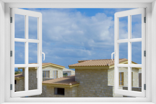 Fototapeta Naklejka Na Ścianę Okno 3D - Construction of the stone house on a background of blue sky, Hersonissos Greece