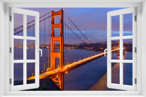 Fototapeta Naklejka Na Ścianę Okno 3D - Sunset Golden Gate Bridge - A cloudy-winter-day sunset view of Golden Gate Bridge, looking from Hilltop at Marin Headlands toward San Francisco Peninsula at south. San Francisco, California, USA. 