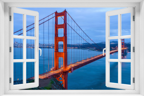 Fototapeta Naklejka Na Ścianę Okno 3D - Golden Gate Bridge at Dusk - A cloudy winter evening view of Golden Gate Bridge, looking from Hilltop at Marin Headlands toward San Francisco Peninsula at south. San Francisco, California, USA. 
