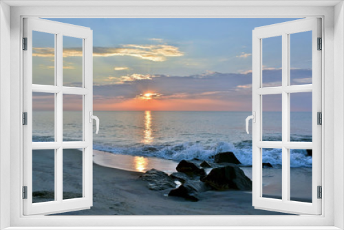 Fototapeta Naklejka Na Ścianę Okno 3D - Rock Jetty on Beach Beneath A Summer Sunrise