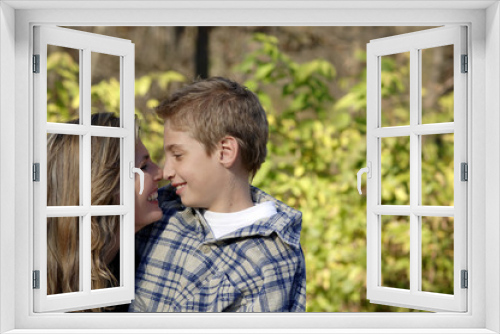 Woman and boy rubbing each others nose