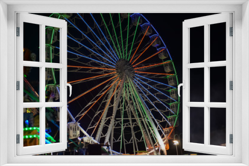 Fototapeta Naklejka Na Ścianę Okno 3D - Colorful blurry lights of amusement park ferris wheel and rollercoaster on the night background
