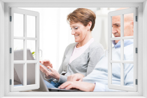 Middle-aged husband and wife surfing the internet