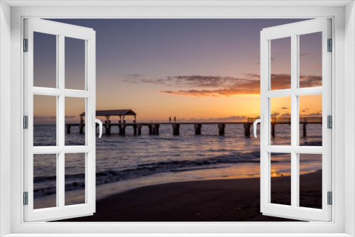 Fototapeta Naklejka Na Ścianę Okno 3D - Photo of Waimea Town pier at sunset taken with long exposure used to smooth and blur the ocean.